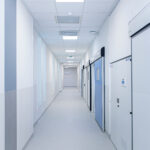 Modern hospital corridor with hermetic automatic doors, designed for sterile and hygienic medical environments.