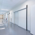 Automatic hermetic hospital doors in a sterile medical corridor, ensuring hygiene, safety, and smooth accessibility.