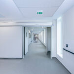 Automatic hospital doors in a clean, modern medical facility, ensuring hygiene, accessibility, and infection control.